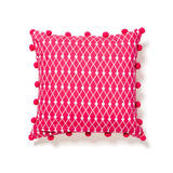 Pink and orange pillow with pom poms at maeree
